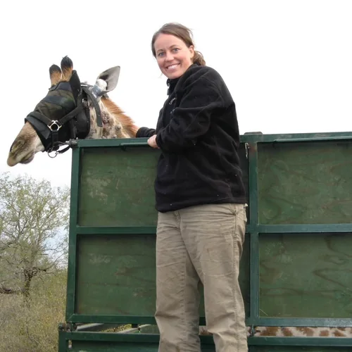 Tara during wildlife veterinary fieldwork with a giraffe